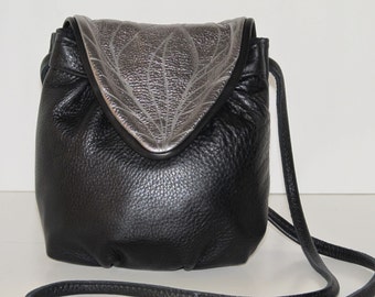 Black leather bag with silver metallic flap