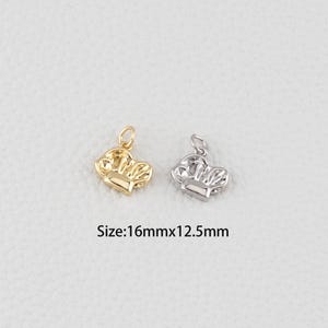 May include: Two small chef hat charms, one gold-colored and one silver-colored, are displayed against a neutral background. The charms are approximately 0.63 inches by 0.5 inches in size. The image includes the text "Size: 16mmx12.5mm".