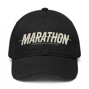 May include: Black baseball cap with the word "MARATHON" embroidered in white across the front. The text "LOCATION: TAU CETI IV // STATUS: ACTIVE" is below the word "MARATHON". The cap has a curved brim and a button on top.