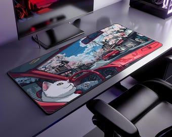 May include: A long rectangular mousepad featuring a cartoon illustration of a white cat driving a red car. The car's interior and the road ahead are visible, with a scenic background of cherry blossoms and buildings. The mousepad is designed for gaming.