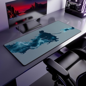 May include: A rectangular gaming mouse mat with a warrior silhouette and sword design, set against blue smoke. The mat is grey and sits on a desk. A computer monitor and other accessories are visible in the background.