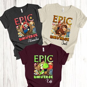 May include: Three short-sleeved t-shirts with cartoon graphics. The shirts are black, beige, and burgundy. Each shirt has the word "EPIC" above a cartoon character and the words "UNIVERSE" and a name below the character.