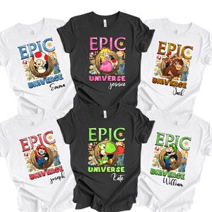May include: A collection of white and black t-shirts featuring colorful cartoon character designs. Each shirt has the word "EPIC" above a character image and the word "UNIVERSE" with a name below. The characters include Toad, Princess Peach, Donkey Kong, Mario, Yoshi, and Luigi.