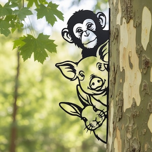 May include: Black metal garden art featuring a monkey, pig, and rabbit peeking out from behind a tree trunk. The whimsical design adds a playful touch to outdoor spaces. The animals are cut out in a simple, cartoon style.