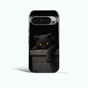May include: Black phone case featuring a digital illustration of a black cat with glowing orange eyes. The cat is resting on a gray brick ledge. The phone case has a black border and a camera cutout.