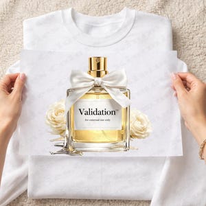 May include: A rectangular perfume bottle with a gold cap and a white bow. The bottle is filled with a golden liquid and has the word "Validation" printed on a white label. Two white roses are on either side of the bottle.