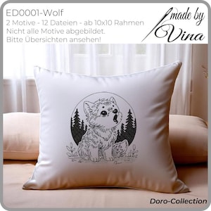 May include: A white cushion with a black and white drawing of a wolf cub howling, surrounded by pine trees. The cushion has the text "ED0001-Wolf" and "Doro-Collection".