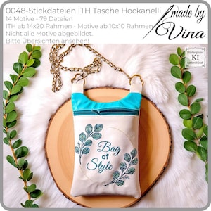 Può includere: Una borsa a tracolla color crema con parte superiore e cerniera turchese. La borsa presenta un design ricamato con la scritta "Bag of Style" circondata da rami frondosi. Ha una tracolla a catena dorata.