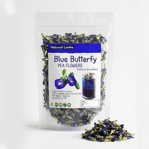 May include: A clear plastic bag filled with dried blue butterfly pea flowers. The bag has a label with the text "Natural Lanka Blue Butterfly Pea Flowers". The label also shows an illustration of the flowers and a blue drink.