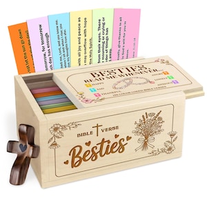 May include: A wooden box set with the text "Besties" and "Bible Verse" engraved on the front. The box contains colorful cards with Bible verses. A wooden cross with a heart is attached to the side.