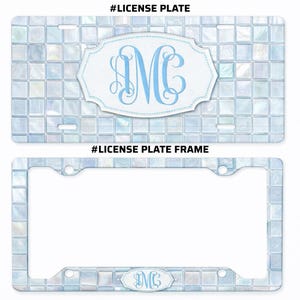 May include: A license plate and license plate frame with a mosaic tile pattern in shades of blue and white. The license plate features a monogram in light blue within a white, ornate frame. The license plate frame has a matching tile design.