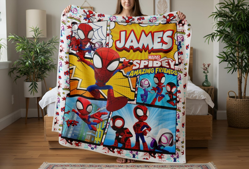 May include: A colorful Spidey and His Amazing Friends blanket featuring a comic book style design. The blanket has a white border with Spider-Man graphics and the name "JAMES" in large letters. The Marvel logo is also visible.