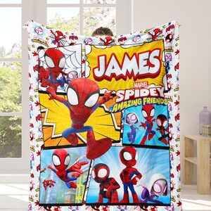 May include: A white blanket featuring a comic book style design with the text "JAMES" and "MARVEL SPIDEY AND HIS AMAZING FRIENDS". The blanket showcases various illustrations of Spider-Man and other characters in vibrant colors.