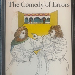 May include: A vintage paperback book cover featuring a black and white illustration of two men in Renaissance-era clothing. The book title is "The Comedy of Errors" by Shakespeare. The cover is yellowed with age and has a Signet Classic logo.
