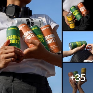 May include: A collection of aluminum cans with the text "SEASONAL FRUITS" in white and orange. The cans are green, orange, yellow, and silver. The cans are held by a person wearing a white shirt. The cans are for a drink.