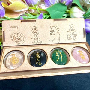 Set van gegraveerde kristallen met reikisymbool: Himalayakwarts, aventurijn, toermalijn, rozenkwarts