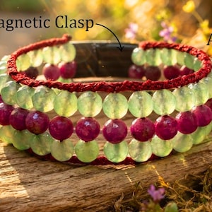 May include: A multi-strand beaded bracelet featuring alternating rows of round green aventurine and deep pink ruby beads. The beads are strung on dark red cord and secured with a magnetic clasp. Text labels identify the components.