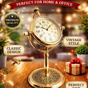 Pode incluir: Um elegante relógio de mesa dourado em estilo vintage. O relógio tem um mostrador redondo com algarismos e ponteiros pretos. A base e o suporte são intrincadamente projetados. A imagem inclui o texto "ELEGANT DESK CLOCK" e "PERFECT FOR HOME & OFFICE."