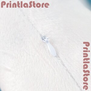 A close-up view of a white fabric surface with a zipper visible, along with the text "PrintlaStore" and "PrintlaStore" repeated in the image.