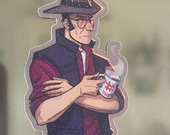 May include: A sticker illustration of a character wearing a brown hat, orange-tinted glasses, a dark vest over a maroon shirt, and holding a white mug with a red hashtag symbol and the text SNIPER printed on the side, with steam rising.