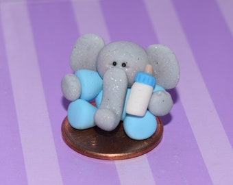 Miniature Elephant in Blue Footy Pajamas with Baby Bottle