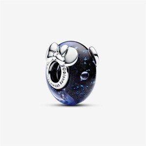 May include: A round charm with a dark blue and black speckled design, featuring a silver bow and two silver Mickey Mouse ears. The charm has the word "Disney" engraved on it.