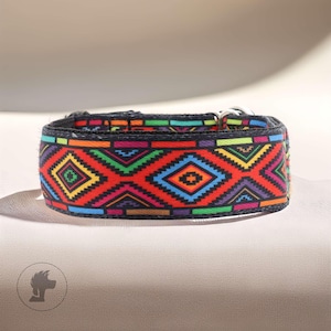 May include: A patterned dog collar with a geometric design. The collar displays a vibrant pattern of red, blue, green, yellow, and purple diamond shapes on a black background. It has a metal clasp.