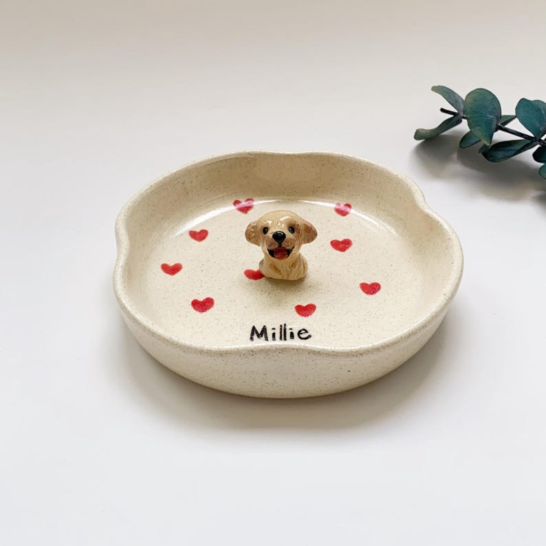 May include: A set of three ceramic mugs with a speckled, matte finish. The mugs are in cream, light grey, and dark grey. Each mug has a simple, minimalist design and a rounded handle.