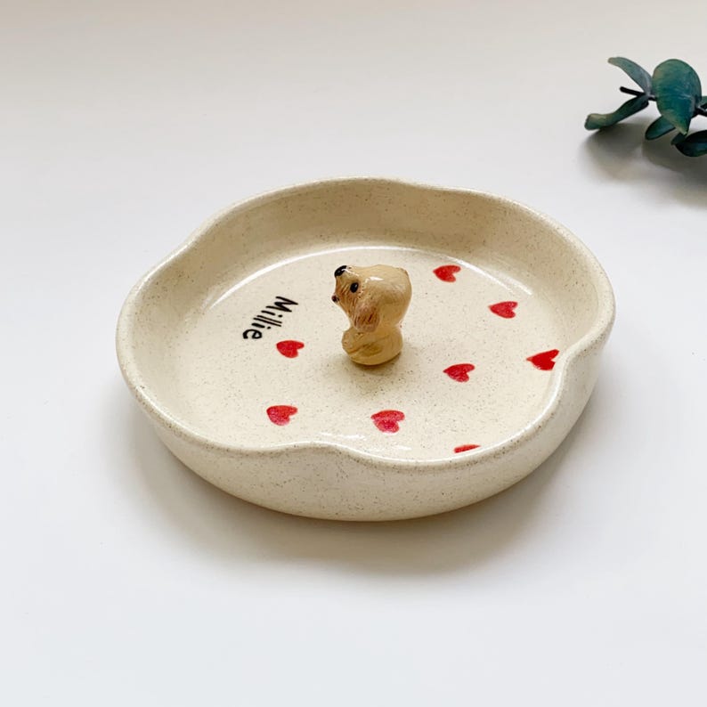 May include: A set of three ceramic mugs with a speckled, matte finish in cream, light grey, and dark grey. Each mug has a simple, minimalist design and a rounded handle.