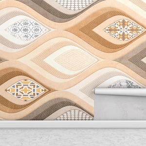 Op de afbeelding: Behang met een herhalend patroon van gestileerde, golfachtige vormen in tinten beige, bruin en grijs. Elke golf bevat een decoratief, geometrisch ontwerp in een contrasterende kleur. Een rol behang is gedeeltelijk afgerold.