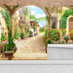 May include: A mural depicting a European village scene with arched doorways and a cobblestone path. Lush greenery and vibrant flowers adorn the buildings, creating a picturesque setting. The sky is a bright blue.