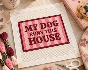 May include: A square needlepoint canvas featuring a pink and white striped background with the dark maroon text MY DOG RUNS THIS HOUSE centered in a rectangular frame. The canvas has cream-colored corner binding tape on all four corners.