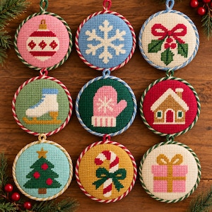 May include: Nine circular cross-stitch ornaments featuring holiday motifs: a red and white bauble, a white snowflake, holly, a white ice skate, a pink mitten, a gingerbread house, a green Christmas tree, a candy cane, and a pink gift box.