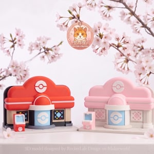 May include: Two miniature building models, one red and one pink, with matching vending machines. The buildings feature a circular logo and a central cylindrical structure. Cherry blossom branches and a cat logo are in the background. The text reads: 3D model designed by RocketLab Design on Makerworld.