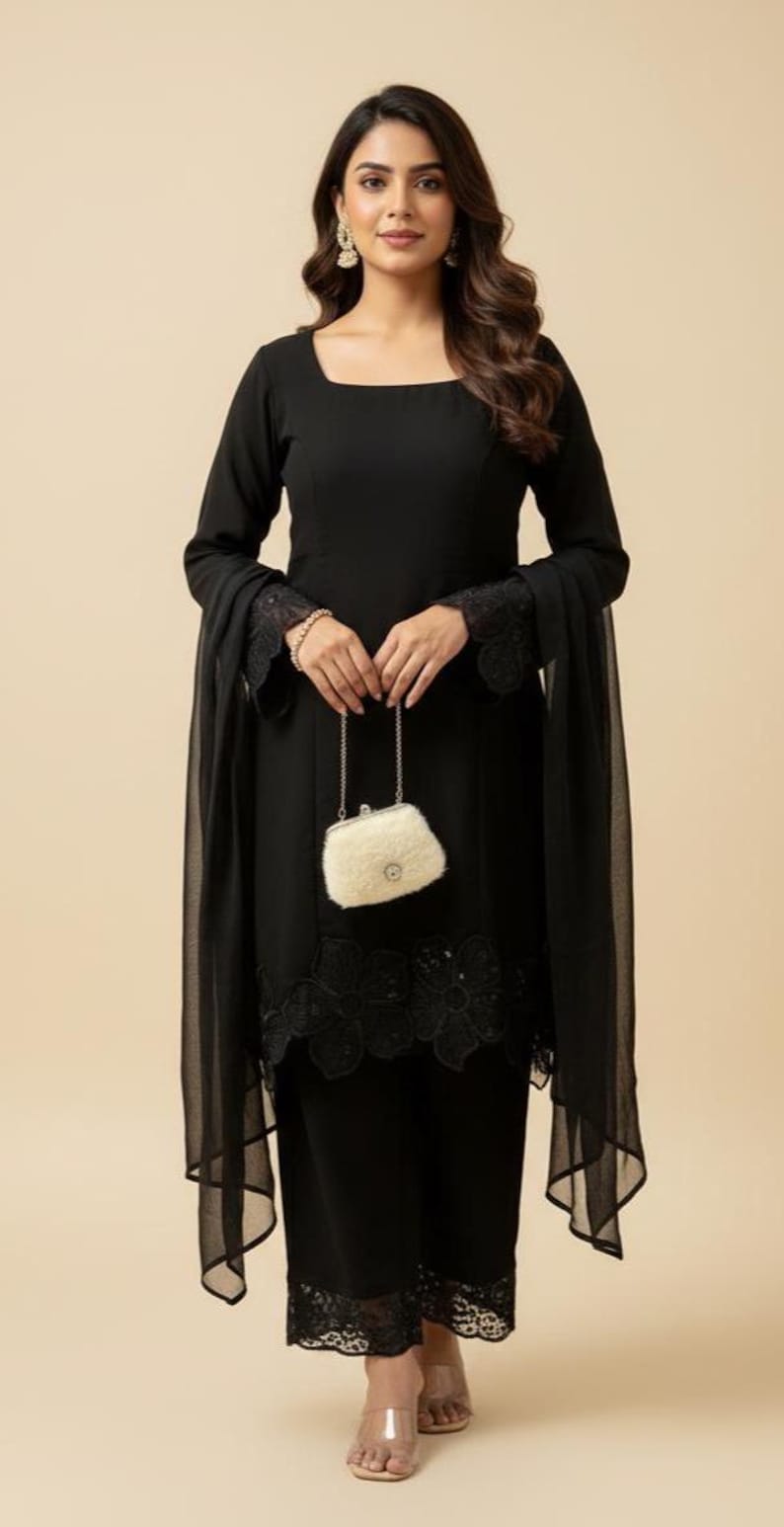 May include: A black ensemble featuring a long-sleeved top with a square neckline and matching pants. The outfit includes a sheer scarf and a small, fluffy, off-white purse. The sleeves and pant hems are adorned with lace detailing.