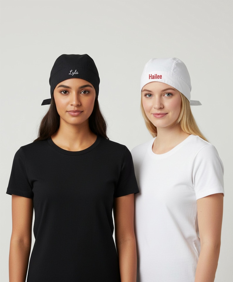 Puede incluir: Dos mujeres con camisetas negras y blancas y gorras a juego. La gorra negra tiene el nombre "Lyla" bordado en blanco, mientras que la gorra blanca tiene "Hailee" en rojo. Las gorras est&aacute;n atadas por detr&aacute;s.