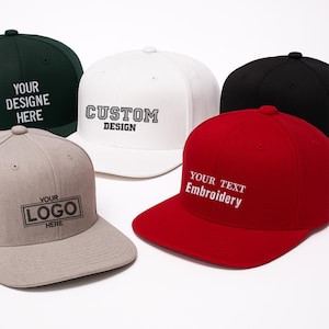 May include: Five baseball caps in various colors: dark green, white, black, red, and tan. Each cap features custom text or a logo. The white cap says "CUSTOM DESIGN". The red cap says "YOUR TEXT Embroidery". The tan cap says "YOUR LOGO HERE".