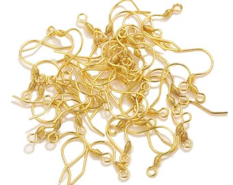 May include: A collection of gold-coloured earring hooks, set against a white backdrop. The hooks are crafted from thin wire and feature a curved design with a looped end and a coiled spring detail. These jewellery findings are for DIY earring making.