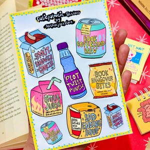 May include: A sticker sheet titled Cutiepatootie Stickers by Allthatjazzstore featuring colorful illustrations of food and drink items with text including Smut Sandwich Cookies, Book Boyfriend Brew, Plot Twist Punch, Book Hangover Bites, Smut Juice, and Sad Ending Soup.