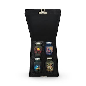 May include: Four small decorative urns with nature-themed designs, including birds, a deer, and a horse, presented in a black velvet-lined box with a hinged lid and silver clasp.