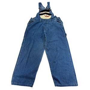 May include: Blue denim overalls featuring a stitched snowman applique on the chest bib. The snowman has a black top hat, a carrot-colored nose, and a smiling face. The overalls include adjustable shoulder straps with metal buckles and side buttons.