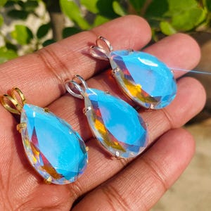 Teardrop shaped Angel Aura Quartz pendant with luminous rainbow shine in sterling silver. Handmade crystal necklace designed for women who love boho and healing gemstone jewelry.