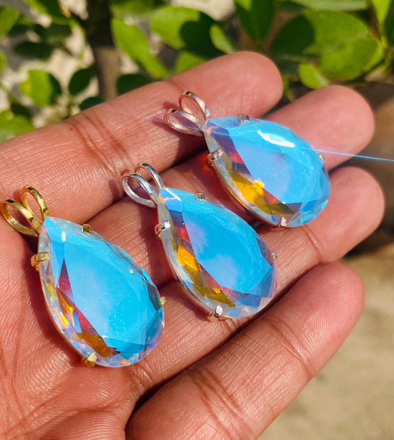 Teardrop shaped Angel Aura Quartz pendant with luminous rainbow shine in sterling silver. Handmade crystal necklace designed for women who love boho and healing gemstone jewelry.