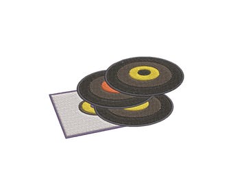 May include: An embroidered patch featuring three stacked black vinyl records with yellow and orange center labels, positioned partially over a white rectangular square with a thin purple border, rendered in a detailed machine embroidery style.