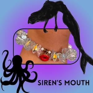 May include: A bracelet with clear, iridescent crystal beads, pearls, and a red lip charm. The text "SIREN'S MOUTH" is displayed on a purple and blue background, with a black mermaid illustration and an octopus silhouette.