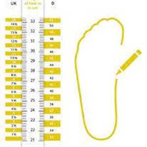 May include: A white and yellow foot measuring guide with UK and D size indicators. The guide shows foot lengths in centimeters, ranging from 21 cm to 33 cm. A yellow outline of a foot is drawn with a yellow pencil.