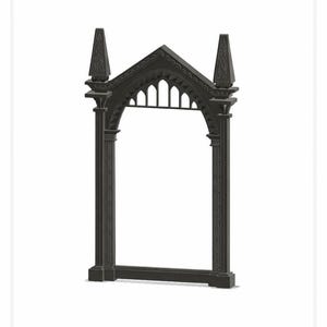 May include: A dark gray architectural archway with a gothic design. The arch features two tall, pointed finials, decorative columns, and a detailed roofline. The open center suggests a frame or decorative element.
