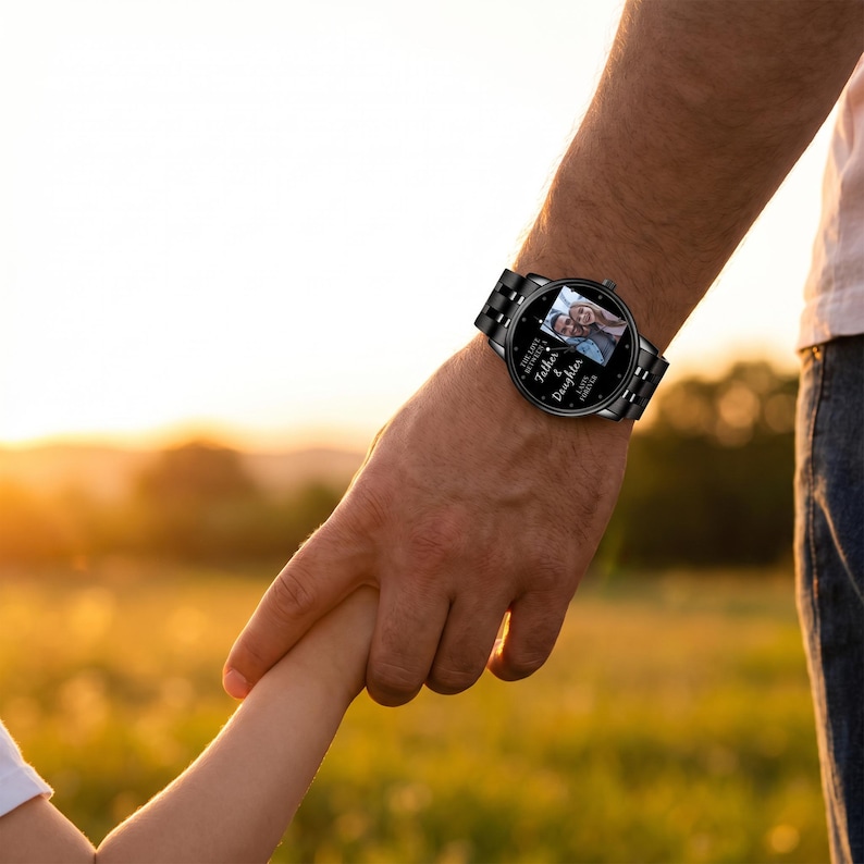 May include: Black wristwatch with a photo of a couple on the watch face. The watch has a black metal band and the words "The Love Between a Father & Daughter Lasts Forever" are printed on the watch face.