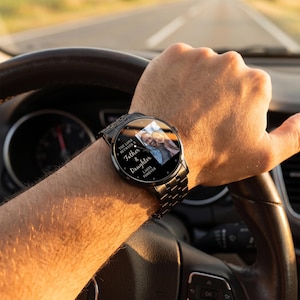 May include: A black wristwatch with a metal band displays a photo of a father and daughter. The watch face has the text "The Love Between a Father & Daughter Lasts Forever."