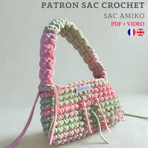 May include: A crocheted handbag in pastel pink and green. The bag has a braided handle and a rectangular body with an "AMIKO" label. The text "PATRON SAC CROCHET" and "SAC AMIKO PDF + VIDEO" is visible at the top.
